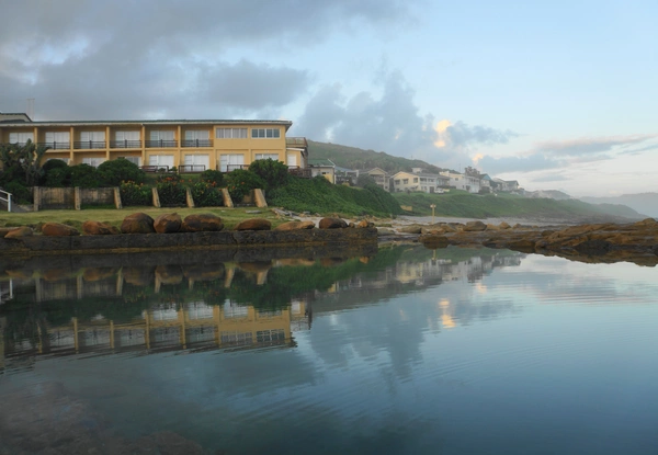 Scenic view of an oceanfront hotel, highlighting its proximity to the beach and coastal beauty. Scenic view of an oceanfront hotel, highlighting its proximity to the beach and coastal beauty.